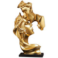 estatua decorativa casal abstrato dourada
